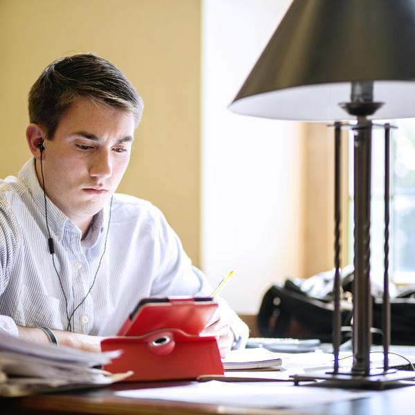 a young man studies ata desk